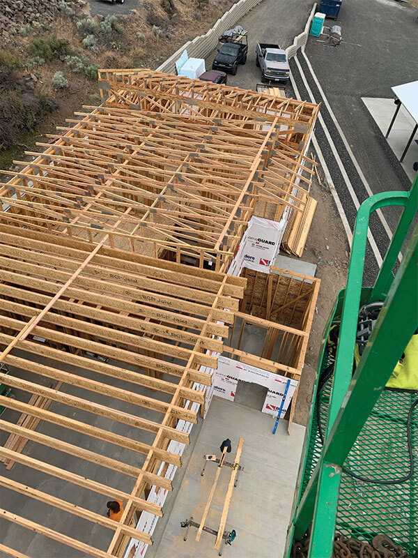 Floor-joist framing staged with a telehandler on a new construction project in Eastern Washington