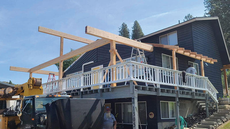 Navy timber-frame custom home with deck under construction by Gitter Done Construction in Eastern Washington