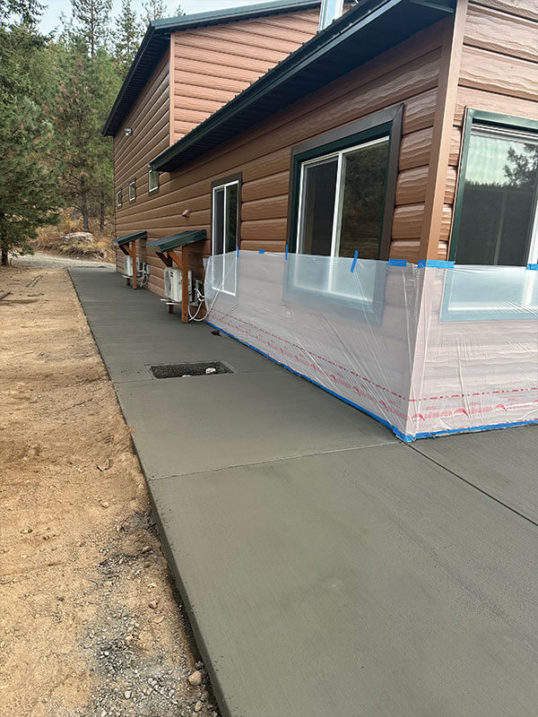 Cedar-sided home with well-maintained concrete walkway in Eastern Washington