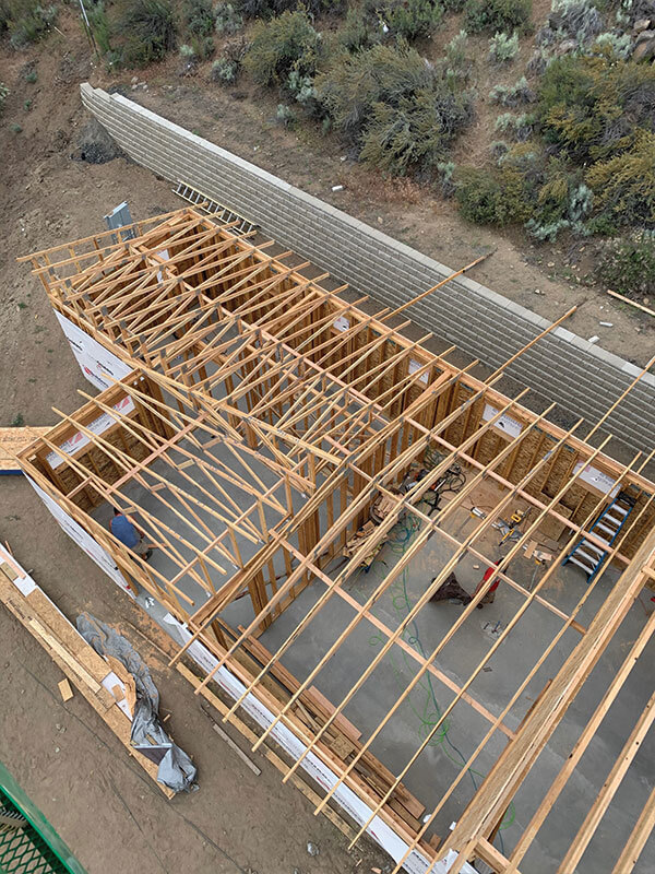 Floor framing in progress on a sloped hillside lot new build in Eastern Washington
