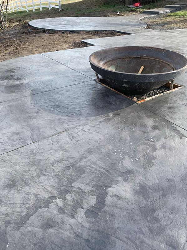 Decorative stamped concrete patio with fire bowl installed by Gitter Done Construction in Eastern Washington