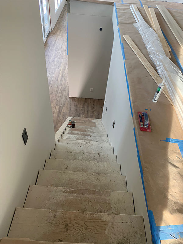 Interior staircase under construction during a flooring and renovation project by Gitter Done Construction