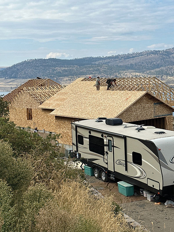 Finished home with completed roof and RV alongside, built by Gitter Done Construction
