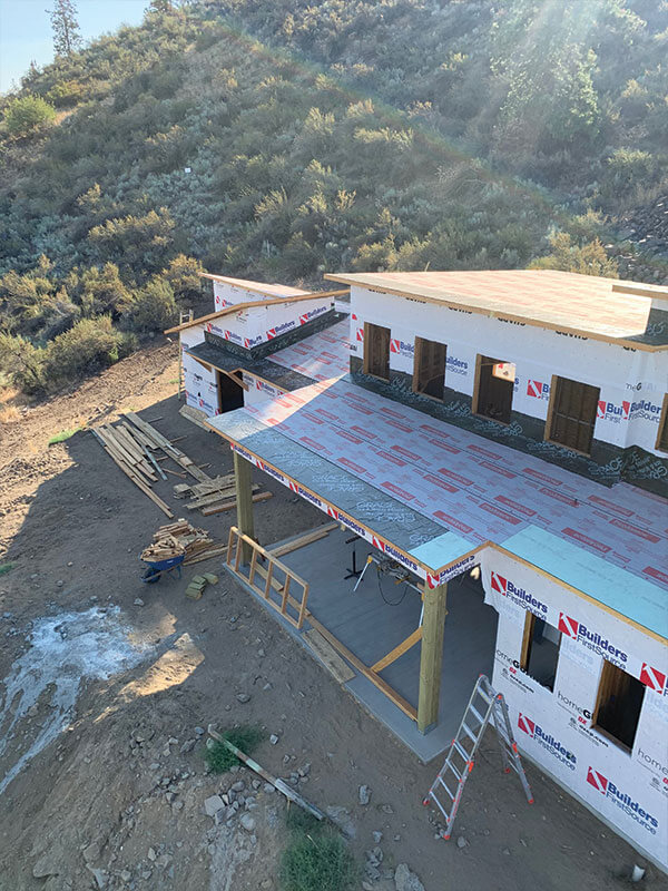 New home with sheathed roof and house wrap completed by Gitter Done Construction in Eastern Washington